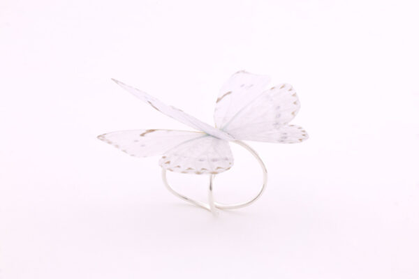 Women silk butterfly sterling silver ring, with adjustable base. The ring has a very strong and resistant silver double base, which can easily be adjusted to your desired size. The enchanting silk butterfly has 2 layers to offer it a 3D design and make it look more as a real butterfly. Due to the properties of silk, the wings move gently with the wearer, making it look like the flutter of a real butterfly. It is a very special and strong ring, even if it looks fragile. Being made of 100% silk, the butterfly is as strong as you silk garment is.