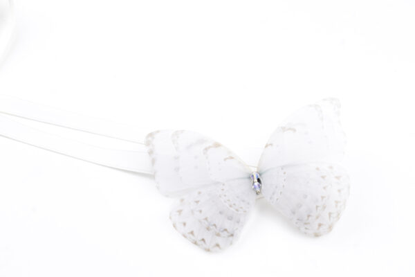 This handmade ribbon tie accessory is meticulously crafted with precision, capturing the likeness of a real butterfly. A versatile accessory that can be worn in multiple ways. Whether styled around your neck as a choker necklace or worn adorning the hair, it fastens with a silk ribbon tie, making the fit fully customizable. The white butterfly and ribbon color makes this accessory suitable for a bride as well, plus, it can be successfully worn after the wedding as well, styling your daily outfits with your favorite accessory.