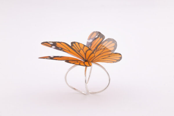 Women silk butterfly sterling silver ring, with adjustable base. The ring has a very strong and resistant silver double base, which can easily be adjusted to your desired size. The enchanting silk butterfly has 2 layers to offer it a 3D design and make it look more as a real butterfly. Due to the properties of silk, the wings move gently with the wearer, making it look like the flutter of a real butterfly. It is a very special and strong ring, even if it looks fragile. Being made of 100% silk, the butterfly is as strong as you silk garment is.