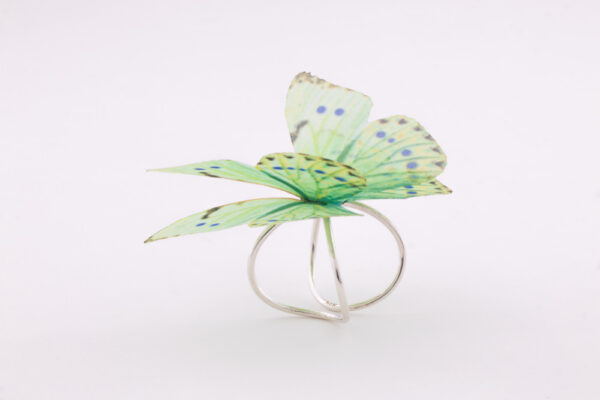 Women silk butterfly sterling silver ring, with adjustable base. The ring has a very strong and resistant silver double base, which can easily be adjusted to your desired size. The enchanting silk butterfly has 2 layers to offer it a 3D design and make it look more as a real butterfly. Due to the properties of silk, the wings move gently with the wearer, making it look like the flutter of a real butterfly. It is a very special and strong ring, even if it looks fragile. Being made of 100% silk, the butterfly is as strong as you silk garment is.
