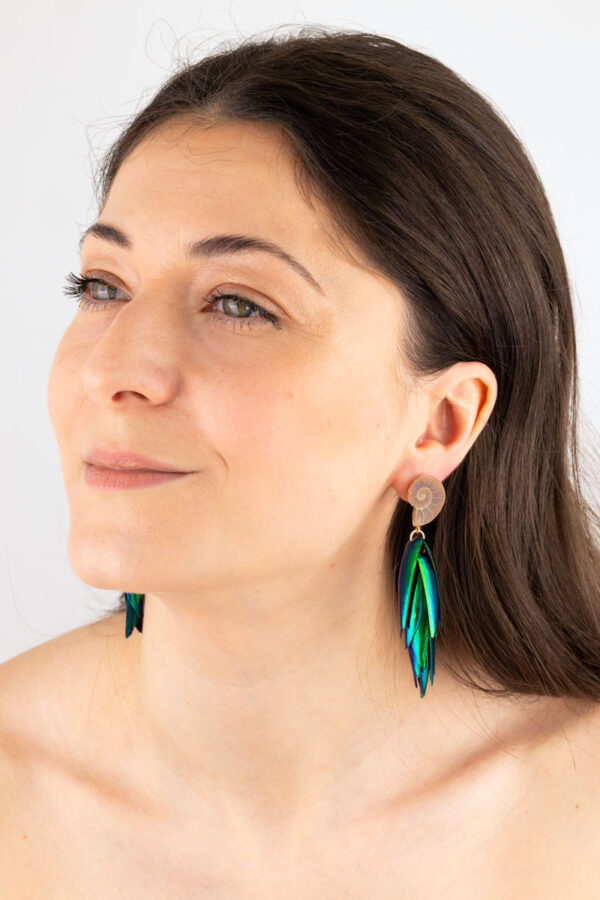 Delicate fossil earrings featuring tiny ammonite shells with earthy tones and beetle, scarab wings