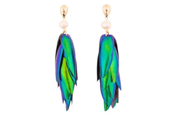 Close-up of white pearls beetle earrings with gold studs detailing on white background